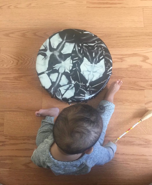 Child looking at Traditional Drum